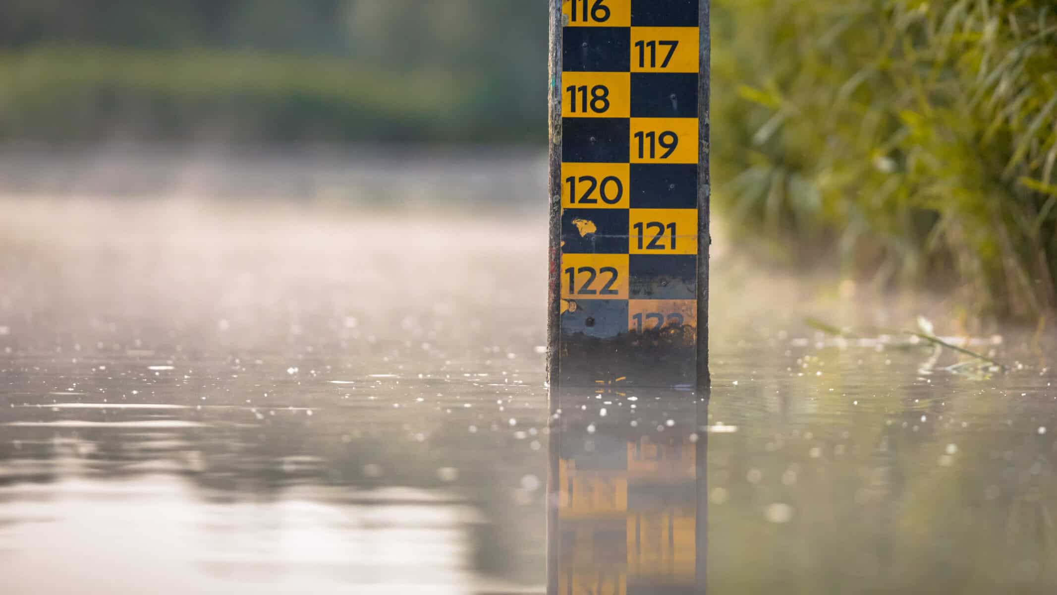 Flood level gauge in water showing flood risk and flood insurance considerations.